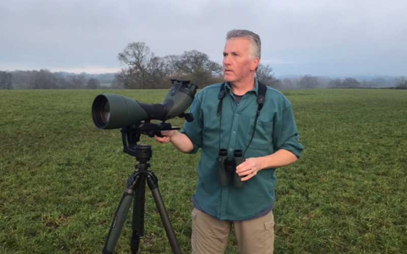 Image of Martin Drew stood with the Swarovski NL Pure 8x42 and BTX Scope Kit in a field