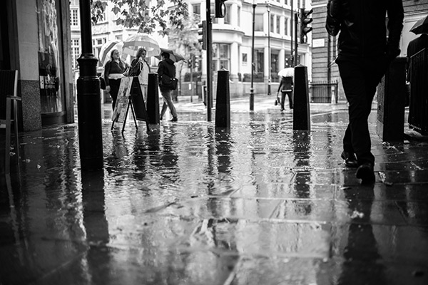 Black and white photo of water rippling in a puddle in London
