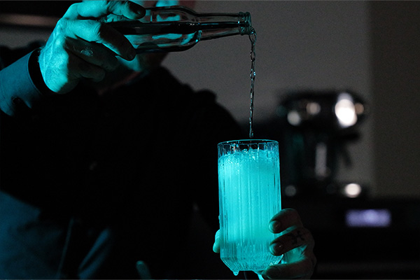 Man Pouring Drink into Glass zoomed in