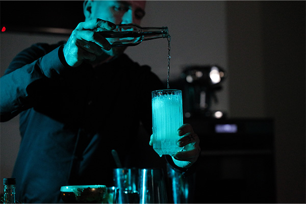 Man Pouring Drink into Glass