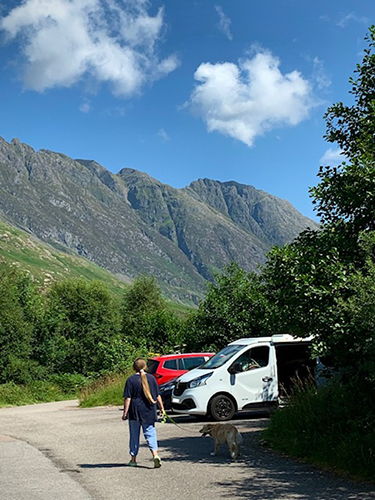 Girl walking towards campervan