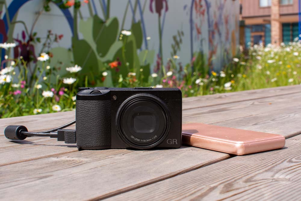 Ricoh GR III connected to external charger
