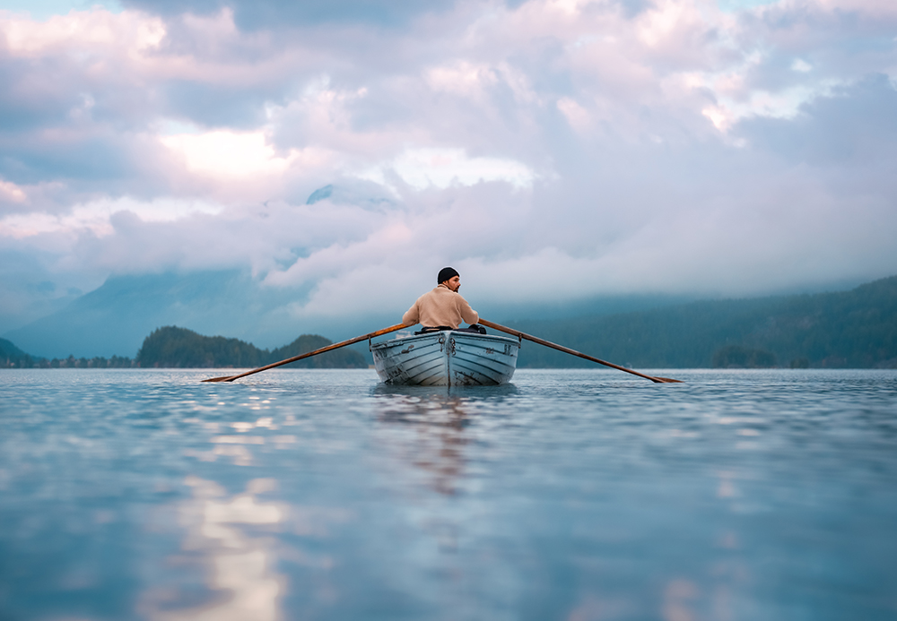 Man on a boat on the lake. Taken on Sony a7 IV