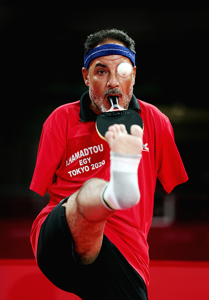 Armless Table Tennis player I Hamadtou serving using his foot at the Tokyo Paralympics