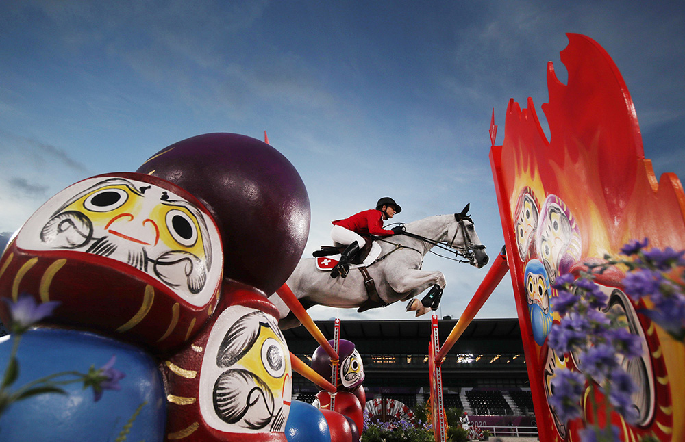 Horse with rider jumping over race jump in Tokyo Olympics