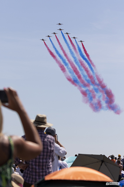 Red Arrows displaying a formation with red and blue stripes at RIAT