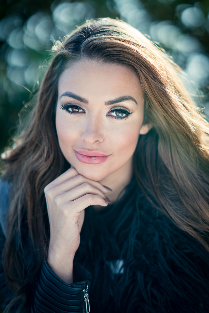 A portrait of a young girl sharply in focus with a blurred background