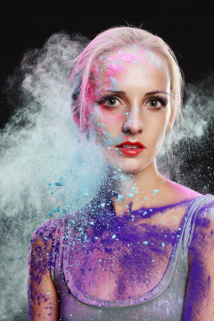 portrait of young attractive girl using coloured powder