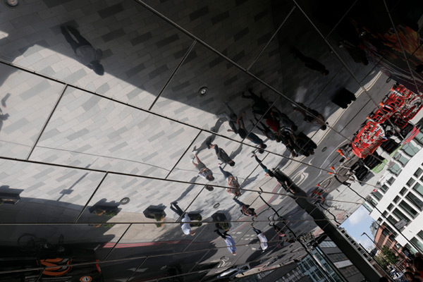 photo of a reflection of people in glass