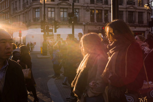 Two women bathed in a ray of light photographed by Robin Sinha