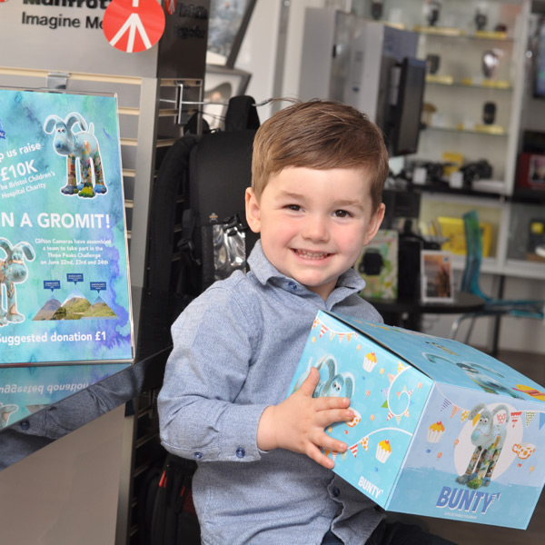 Young Boy Wins Gromit Figurine in Fundraising Raffle at Clifton Cameras