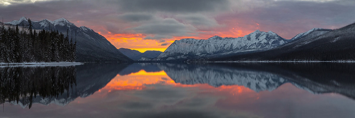 mountain range at sunset mirrored in a lake