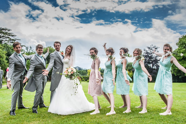 groomsmen and bridal party take fun photo