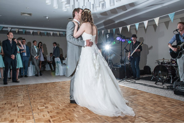 bride and groom first dance with lens flare